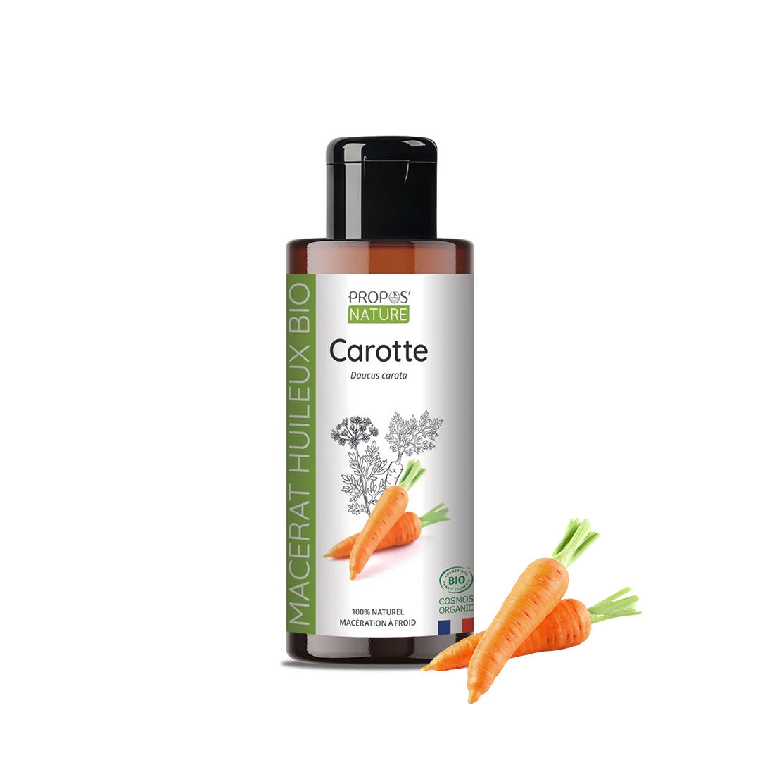 A bottle of Propos Nature Carotte macerat bio, a brown bottle with a black cap and a white label featuring orange carrots, shown on a white background with three loose carrots in front.