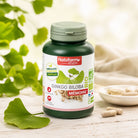 Bottle of Nat&Form Ginkgo Biloba supplement with green leaves in the background