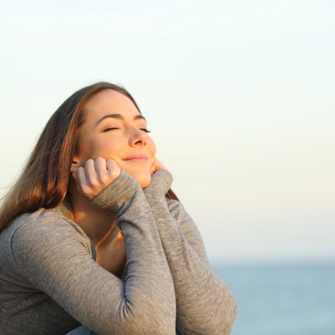 A young woman enjoying the sun in her face