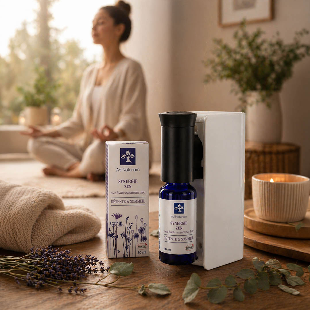 Aromatherapy product with packaging on a table in a serene setting with a person meditating.