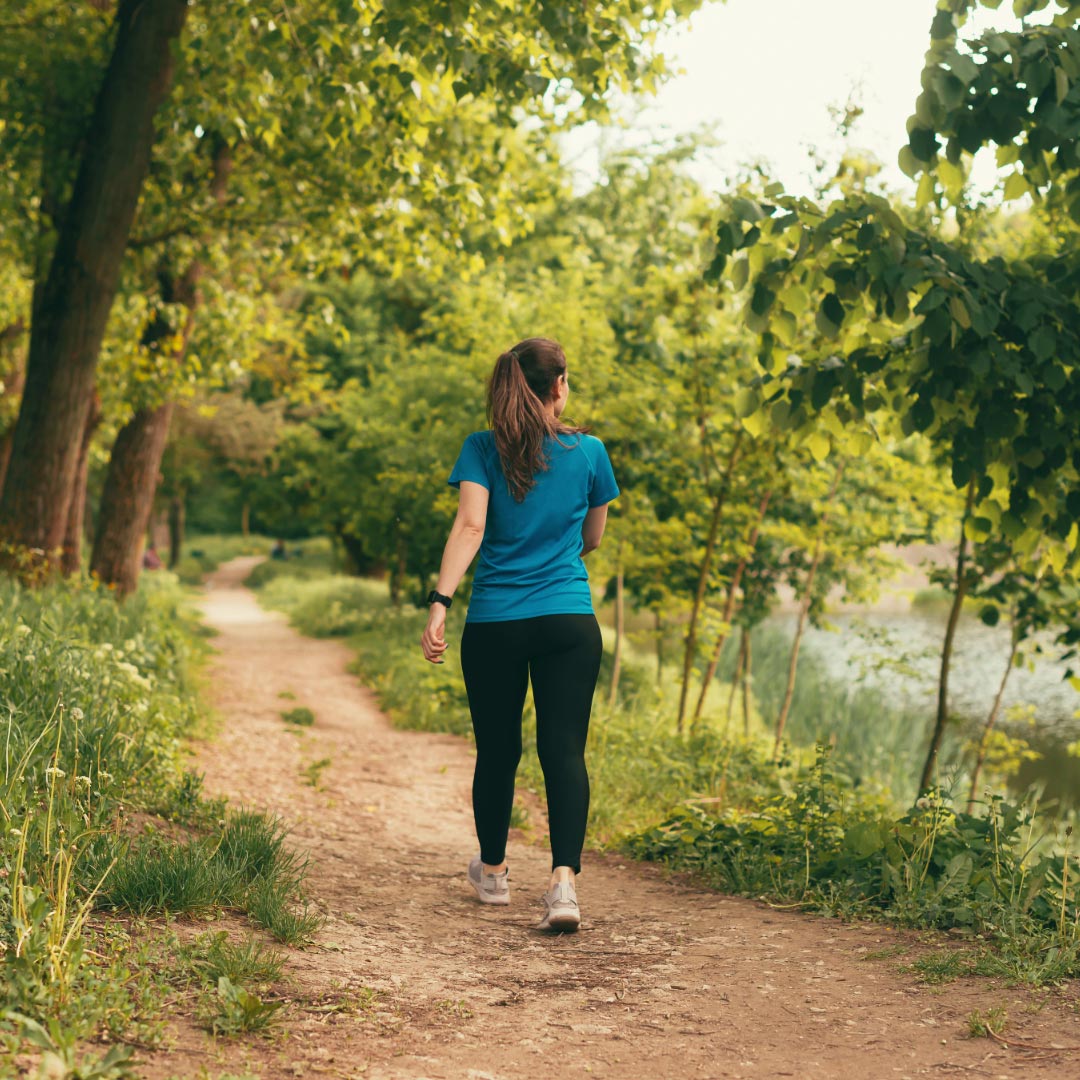 A woman walking a path in nature