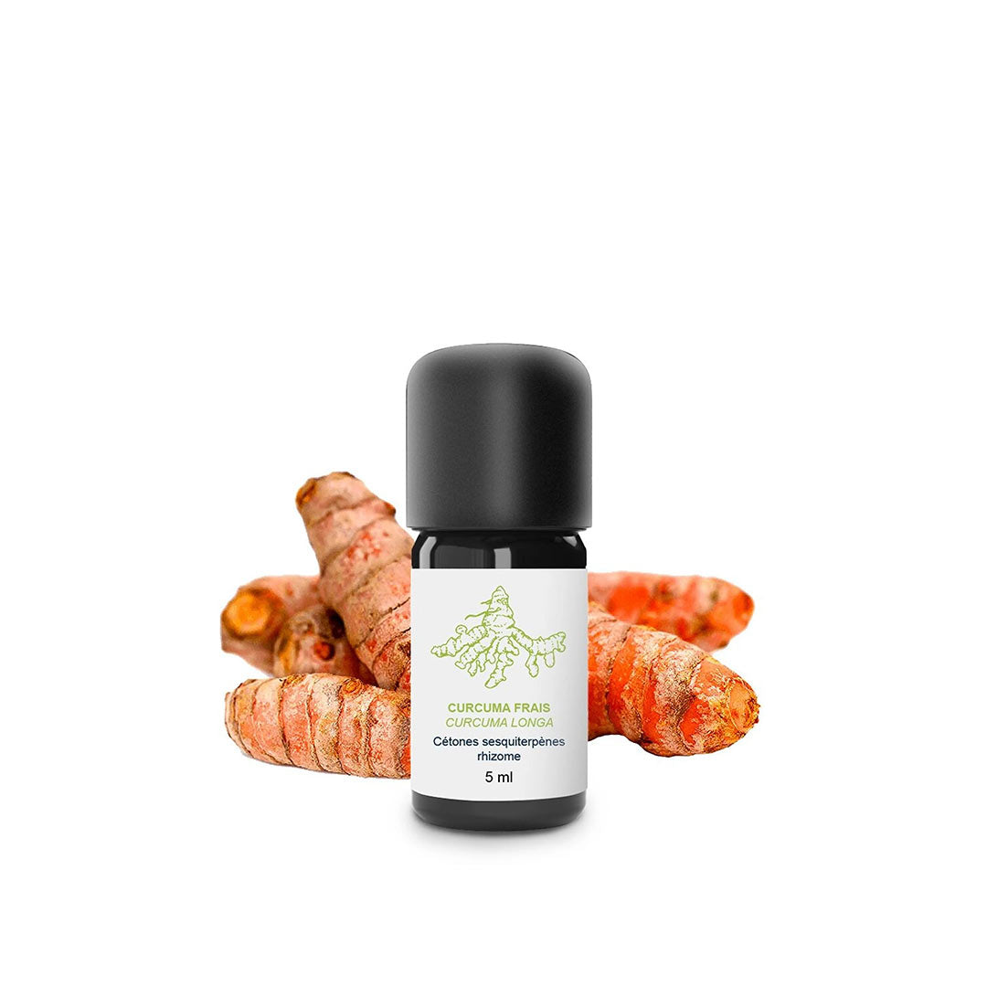 A 5 ml bottle of Turmeric Curcuma Frais essential oil with a black cap and white label, set against a background of fresh turmeric roots.